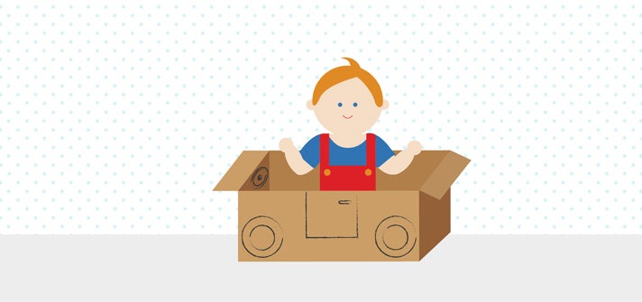 Toddler playing in cardboard box