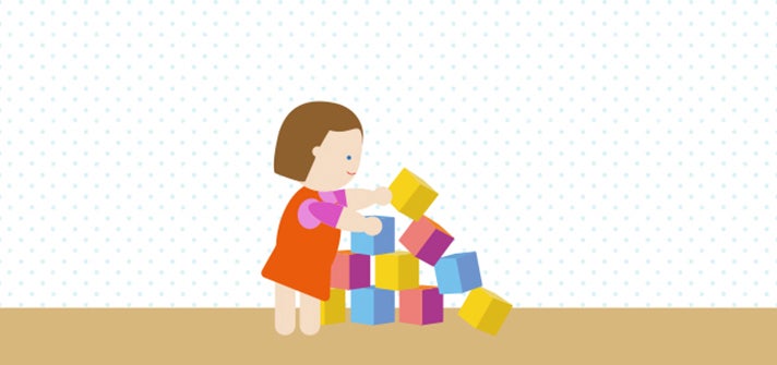 Toddler building with multicoloured blocks 