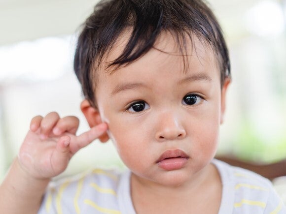 Toddler pointing to his ear