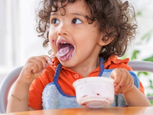toddler eating yoghurt