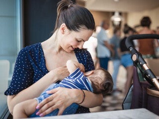 Mother breastfeeding her baby in a public place