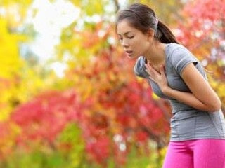 Woman in activewear out of breath.