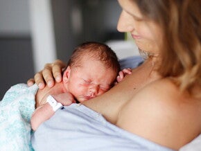 Mother doing skin-to-skin kangaroo care bonding with baby