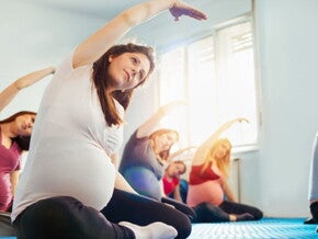 Pregnant woman in a prenatal yoga class with other pregnant mums-to-be