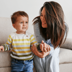 mom holding  toddler hand