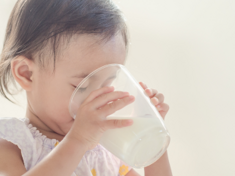 Child drinking milk from cup