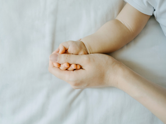 Parent Holding Babies Hand