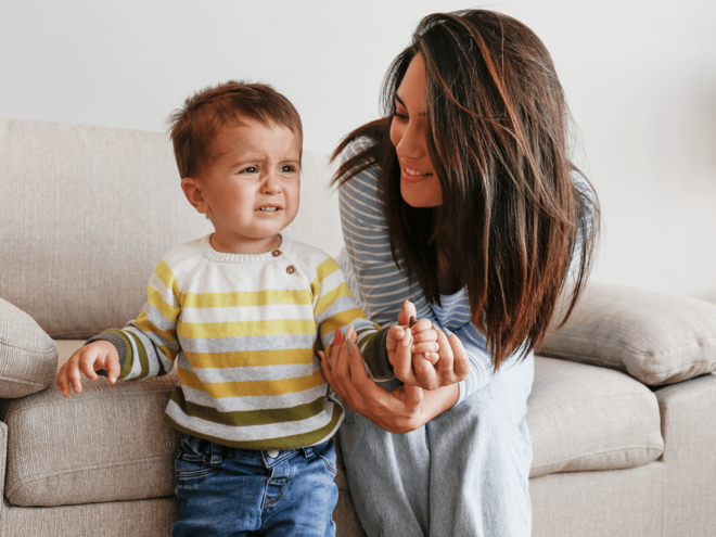 mom holding toddler hand