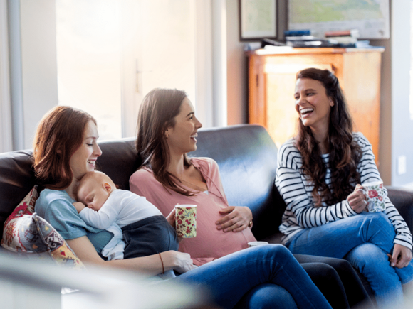 women laughing pregnant and baby