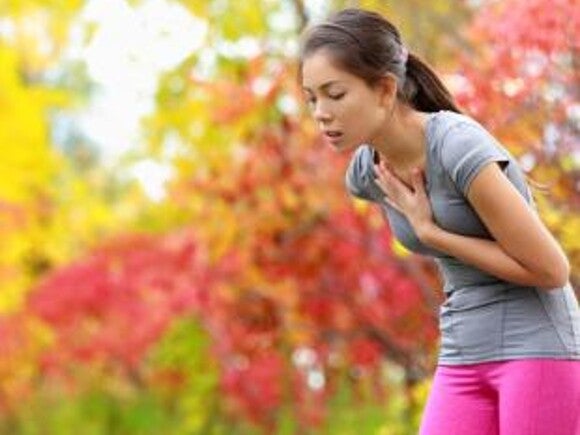 Woman in activewear out of breath.