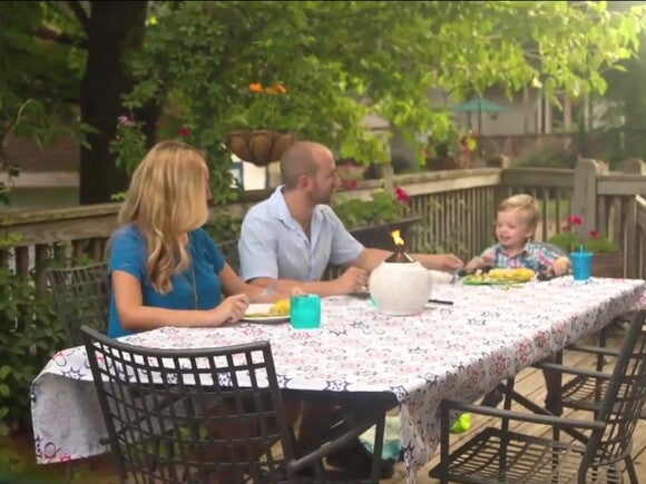 Mother and father with toddler eating outside