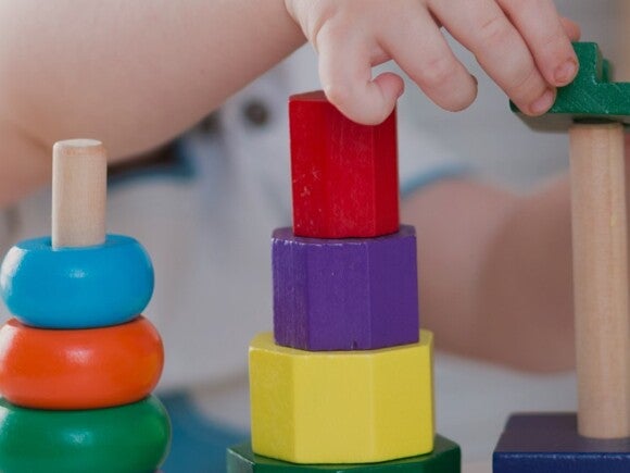 toddler playing with wooden blocks
