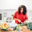 woman in kitchen cutting up healthy food