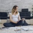 Pregnant woman looking at a tablet